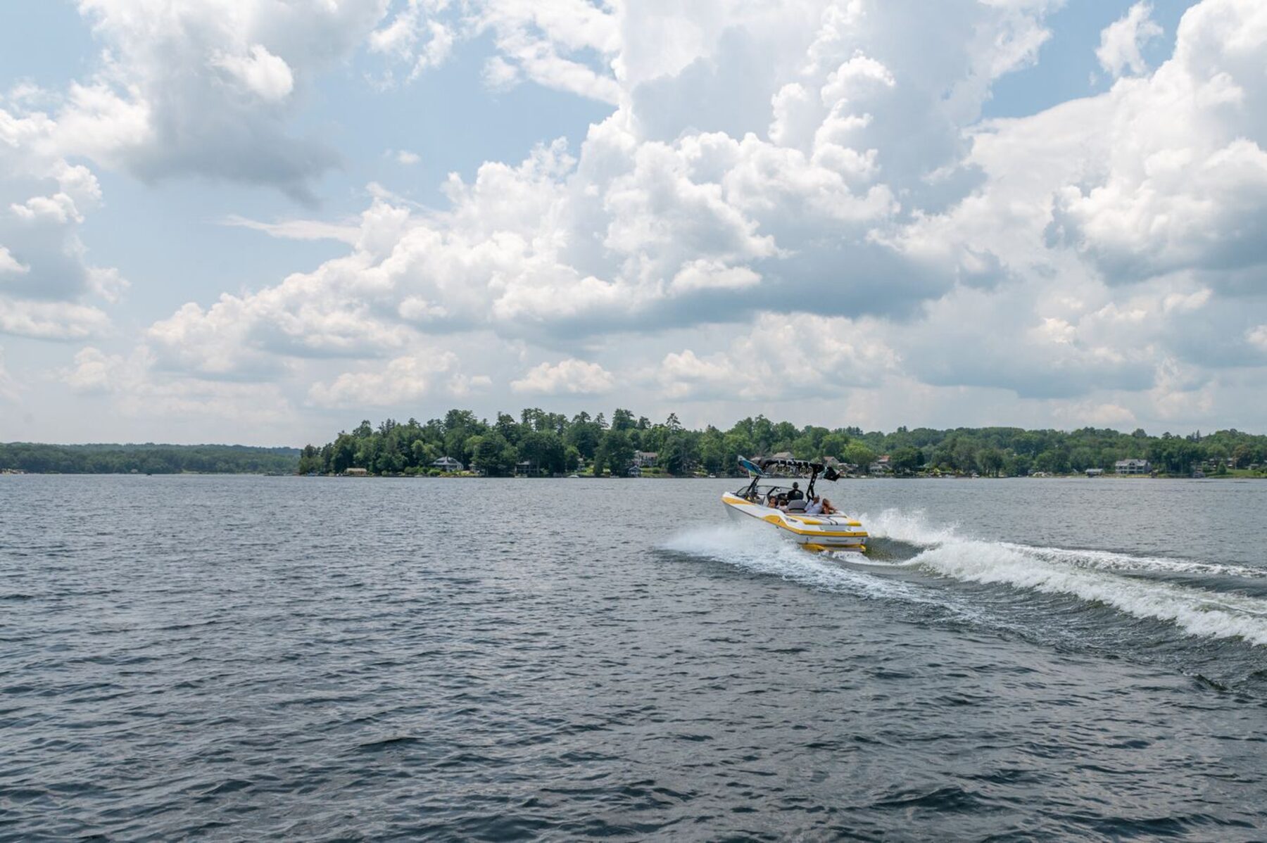 Wide view of a Connecticut lake under a big summer sky